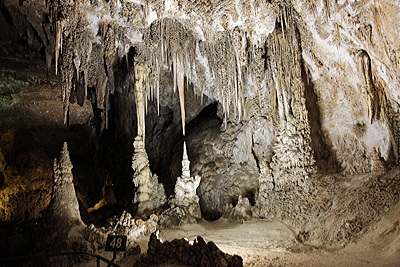 Figure 9.17: Carlsbad Cavern in New Mexico is an extensive cave system formed in the Permian limestone of the Capitan Formation. Uniquely, this and many other karst caves of New Mexico were formed through dissolution by sulfuric acid rather than the more common carbonic acid.