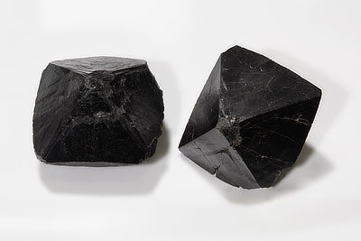 Figure 5.7: Bipyramidal crystals of cassiterite (SnO<sub>2</sub>, tin oxide). Each crystal in the photo is approximately 30 millimeters (1.1 inches) across. 