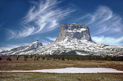 Figure 4.22: Chief Mountain, located in Montana’s Glacier National Park, is a block of Precambrian rock that rests directly atop younger Cretaceous shales as a result of thrust faulting along the Lewis Overthrust. The surrounding thrust sheet has been eroded, leaving behind the mountain as an isolated block.