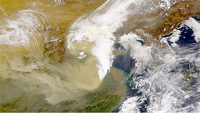 Figure 8.19: Satellite image of China, where continental dust (tan patch at center) blows off of the Gobi desert in a spring storm. Dust storms such as these are important for transporting nutrients to Hawaiian ecosystems.
