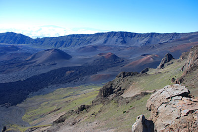 Figure 4.24: Haleakalā, Maui. The summit “crater” of Haleakalā formed by erosional—not volcanic—processes. Two headward-eroding valleys were carved into the sides of the volcano and were later covered by the younger cinder cones seen today.