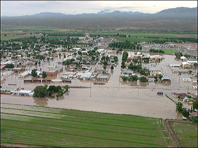Figure 9.27: In August 2006, runoff from heavy rains sent a wall of water into the town of Hatch, New Mexico. No one was injured, but damages exceeded $4 million. The summer of 2006 was a record monsoon season in New Mexico, with a total of 91 flash flood events.