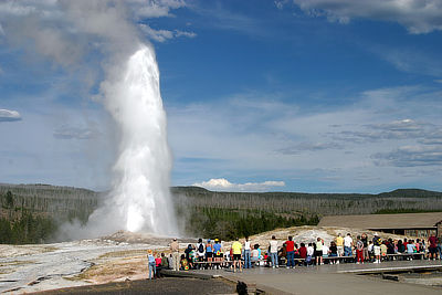 Figure 4.27: Old Faithful geyser erupting at Yellowstone National Park. The geyser is one of the most predictable in the world, with intervals of 60 to 90 minutes between each eruption, which can shoot 32,000 liters (8400 gallons) of boiling water as high as 56 meters (185 feet) and last for up to five minutes.