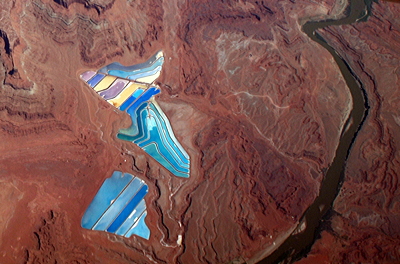5.6: Potash evaporation ponds at the Intrepid Potash mine near Moab, Utah. The Colorado River is located to the right of the ponds, which are dyed blue to enhance evaporation.