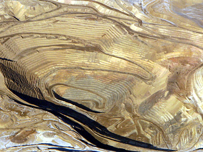 Figure 5.4: An aerial view of Round Mountain gold mine, an open pit mine in Nye County, Nevada. Round Mountain existed as an underground mine beginning in 1906, eventually being converted to an open pit sixty years later. The pit is about 2500 meters (9200 feet) wide and 1493 meters (4900 feet) deep.