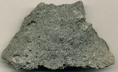Figure 2.39: A piece of vesicular andesite from the flank of the Sierra Grande shield volcano, the largest peak in New Mexico’s Raton-Clayton Volcanic Field. Specimen is 7.3 centimeters (2.9 inches) wide.