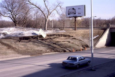 Figure 10.17: This slump occurred along a North Dakota roadcut after a spring thaw melted piles of snow on the upper bank, saturating the clay-rich soil and increasing its weight.