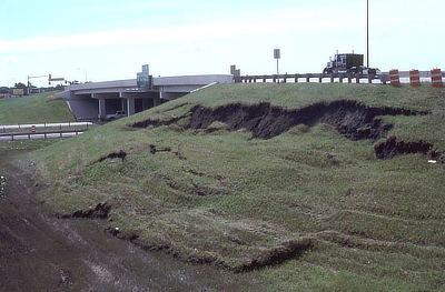 Figure 10.16: This slump near Interstate 29 in Fargo, North Dakota occurred in clay-rich materials used to construct the nearby overpass.