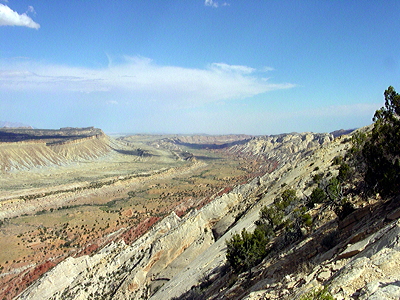 Figure 4.11: A view south along the Waterpocket Fold, Utah, which slopes steeply down across the white Navajo Sandstone. The formation is named for its "waterpockets," small depressions that form when rain erodes the sandstone.